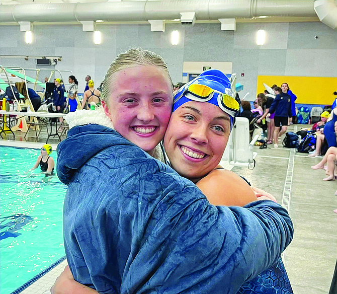 Eatonville's Gracie Forsman and Kaylee Bernt, both new Eatonville High School record holders pose together for a photo at the district swim meet.