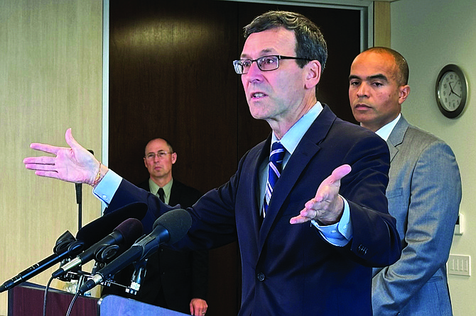 Washington Democratic Gov.-elect Bob Ferguson addresses the media during a news conference in Seattle on Thursday as Attorney General-elect Nick Brown looks on.