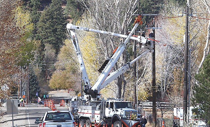 NV Energy linemen work on power poles along Genoa Lane on Wednesday morning as a public safety outage warning was issued by the company.