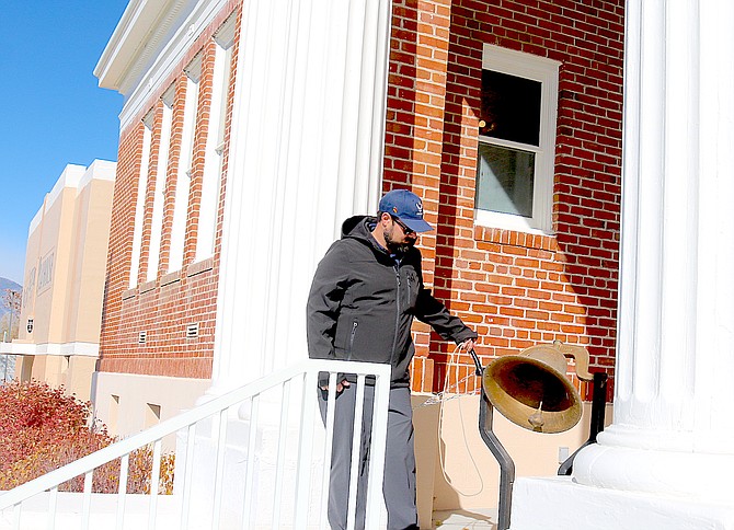 U.S. Air Force retiree Sean Vagenas rings the bell as part of the Armistice Day ceremony at the Carson Valley Museum & Cultural Center on Monday.