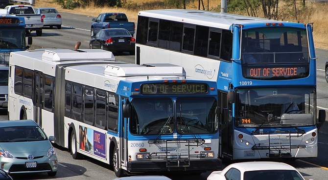 Two Community Transit bus models that are out of service traveling.