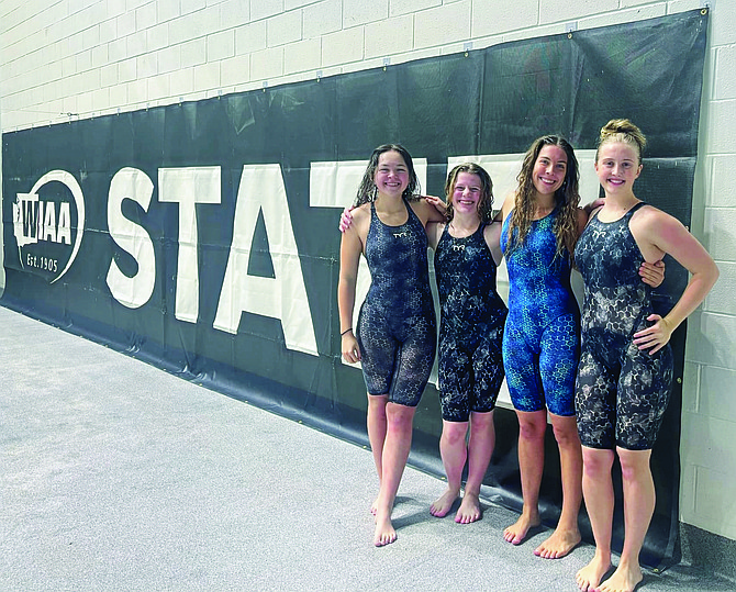 Eatonville's school-record 400 freestyle relay team stopped for a photo during the WIAA State Swim and Dive Championships.