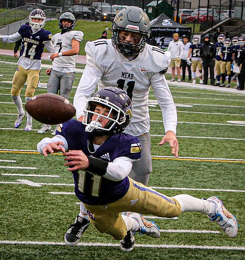 In a desperate try late in the first half, Lake Stevens senior Cannon Kennard stretches for the ball in the end zone during the first round of State 4A Saturday, Nov. 17 at Lake Stevens’ field. The Vikings skidded to a rain-soaked win, 52 - 49 over the Mead Panthers and continued their march to State. In their eighth 50-plus point game, the Vikings still needed a nail biting fourth quarter to pull out the victory.  In a key second period sequence, Mead intercepted a Kolton Matson pass deep in their own end of the field and converted  three plays later to a score.  Lake Stevens’ second round game is Nov. 23 against Chiawana High at Chiawana’s home stadium in Pasco. 
Meanwhile, the Monroe Bearcats lost to Eastside Catholic.  Coming off a 4-game, 40-point-per-game streak, the Bearcats were crushed 37 - 6 to end their season.