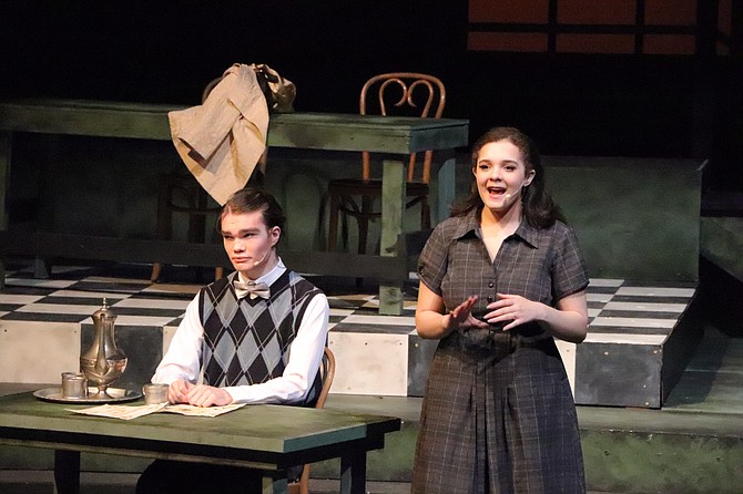 Students Alex Hunt (left) and Rowan Latch (right) onstage during Glacier Peak High School’s November 13 dress rehearsal for their production of Radium Girls. Grace Fryer, played by Latch, was a dial painter and leading figure in the lawsuit against the U.S. Radium Corporation.