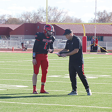 PCHS head coach Mike Brooks gives Travis Donaldson the play.