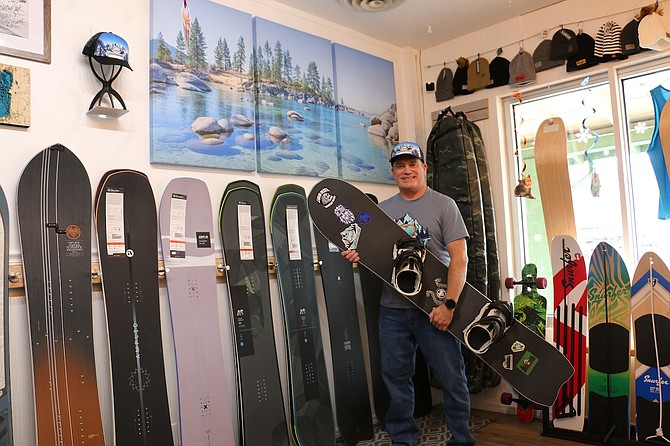 Sean Sudduth, owner of Carson City’s new snowboarding shop Mountain Cat at 1815 N. Carson St., displays a selection of snowboards and gear for outdoor enthusiasts.