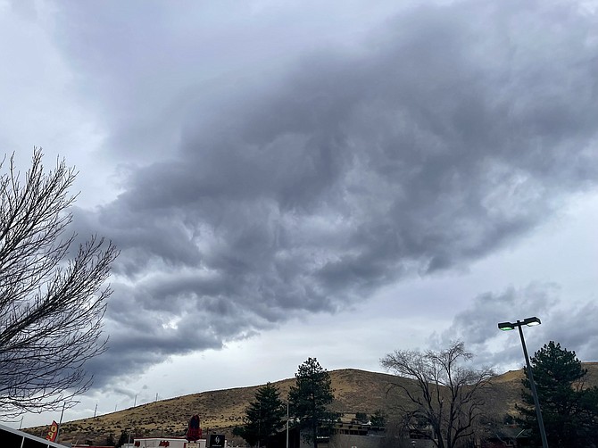 Scott Neuffer/Dark storm clouds rolling over the foothills of south Carson on Friday afternoon.