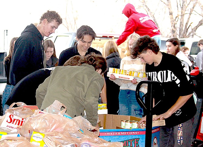 Douglas High School Block D members unload the food they purchased from Smith’s for the Carson Valley Food Closet.