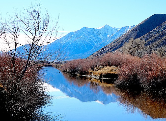 Jobs Peak is reflected in Brockliss Slough on Sunday morning.