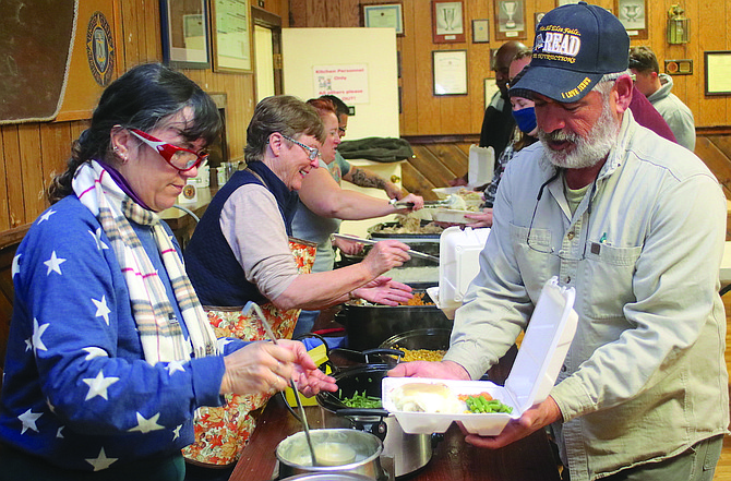 Tina Glushenko, left, and Dave Santos prepare Thanksgiving meals at a prior volunteer outreach at Fallon’s American Legion Fred W. Anderson Post 16.