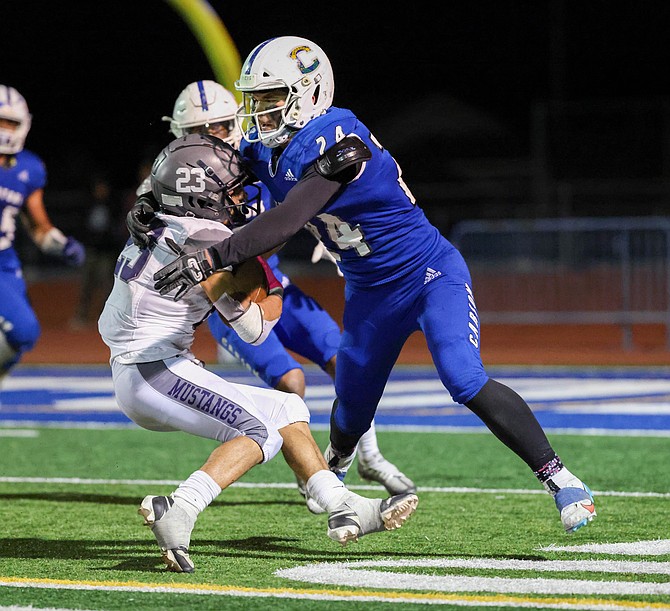 Carson senior linebacker JT Heaton wraps up a ballcarrier this fall. Heaton was named the 5A North Division III Defensive Player of the Year after leading the division in tackles with 133.