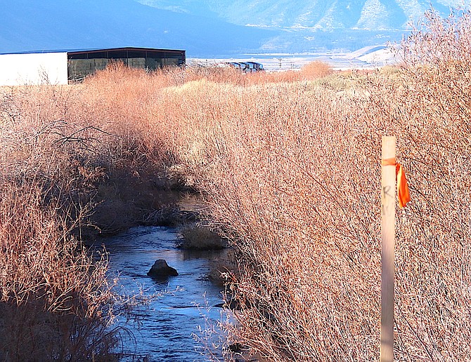 A stake showing the right of way for Muller Parkway stands along the Virginia Ditch at Buckeye Road.