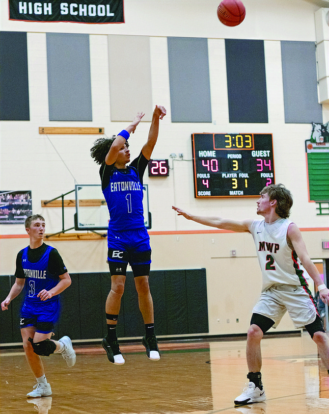 Eatonville's Amari Samuel shoots over Morton-White Pass's Judah Kelly scoring 3 of his team high 20 points in the Cruisers 66-60 loss to the Timberwolves this past Saturday night.