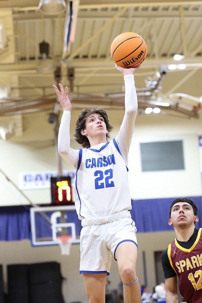 Carson High’s Landon Hoff goes up for a floater against Sparks in the Senators’ season opener.