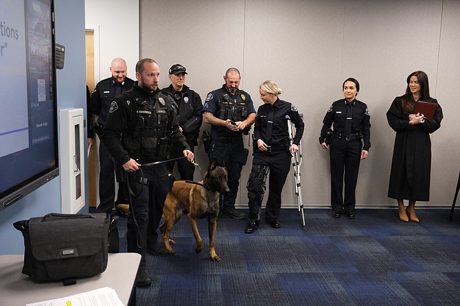 Officer Marc Schuermeyer with Belgian Malinois Apollo. The K9s is a tracker with the Monroe Police Department.