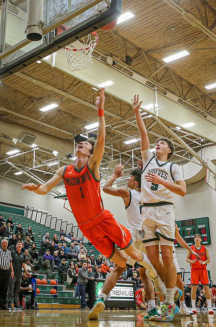 Monroe Bearcat Caleb Campbell, who had a game-high 24 points, flies during first quarter play against Jackson on Tuesday, Dec. 3 at Jackson High.
The Monroe Bearcats played an aerobatic game with a strong second quarter and big defense to roll over Jackson 72 - 50 before a sparse crowd in Jackson’s gym.