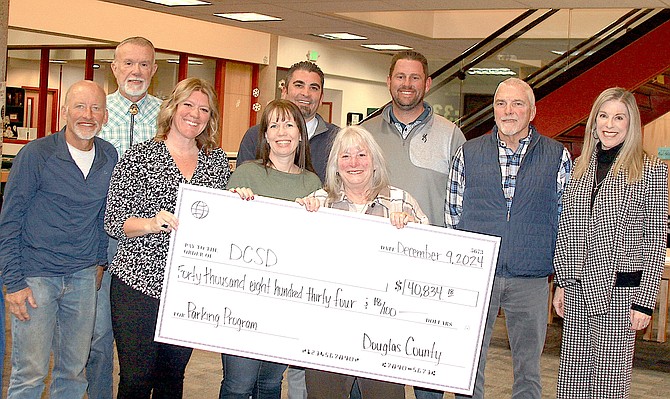 Douglas County School District Board of Trustees and Superintendent Frankie Alvarado accepted a $40,834.18 check from Douglas County. The check is the school district’s share of the revenue from the Warrior Way Paid Parking pilot program implemented June 2023-Sept. 2023. Community Service Director Brook Adie and Community Service Deputy Director Ryan Stanton presented the check.