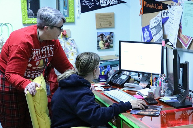 Carson High School counselor Bridget Gordon-Johnson assists junior Betsy Campbell-Richards with her U.S. Department of Education Free Application for Federal Student Aid form.