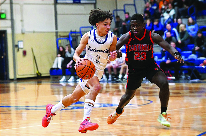 Eatonville's Amari Samuel drives past Orting's MJ Mbuyamba on his way to scoring a game-high 33 points.