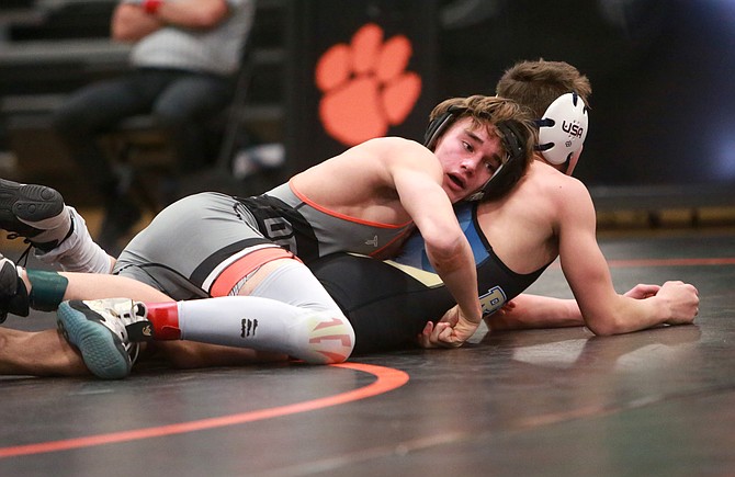 Douglas High’s Isaac Bedrosian works for back points against a Reed opponent during the Tigers’ home triangular earlier this year. Bedrosian took fourth place at the Cody Louk Invitational this past weekend at 126 pounds.