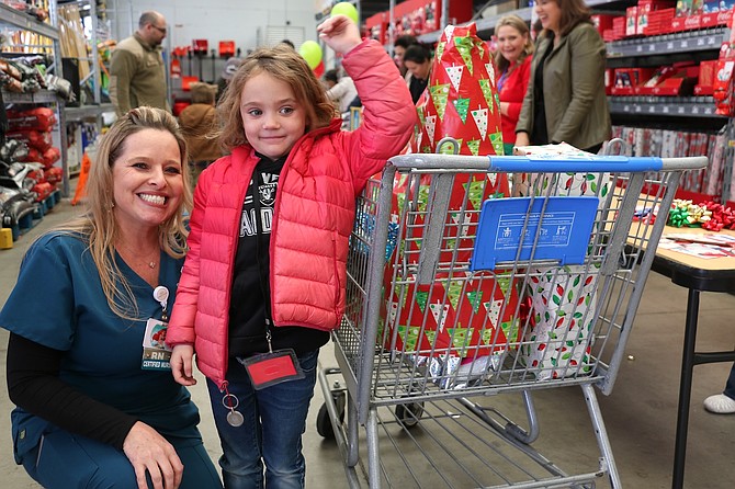 Carson-Tahoe Regional Medical Center registered nurse Becky Duffy and Evelynn Ostin of Fritsch Elementary School at Holiday with a Hero on Dec. 18, 2024 at the Market Street Walmart.