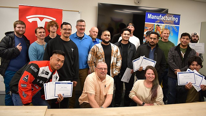 WNC instructors and Tesla representatives are pictured with Tesla Start students at a special certification ceremony on Dec. 12 at WNC.