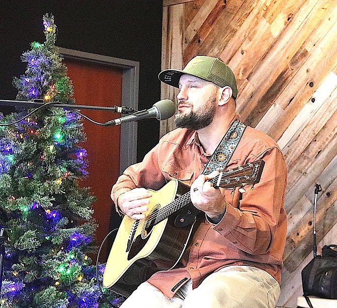 Roland Haas plays guitar and sings at the Douglas Community & Senior Center’s 10th anniversary celebration.