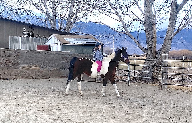 A Jacks Valley Elementary School student rides a horse at Between Horses and Humans.