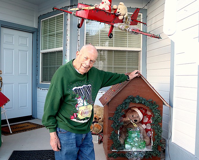 Roy Nisja stands next to the bubble-blowing bear built by his son Donn as part of the Bear House at 1366 Chichester Drive in Gardnerville.