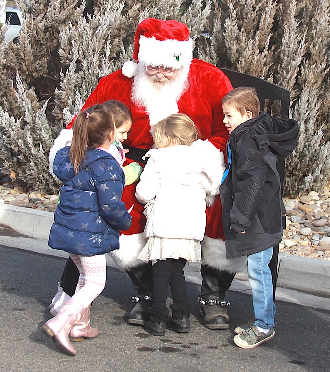 Children swarm Santa at the Dec. 13 Channel 2 Share Your Christmas Drive-by Food Drive at the Carson Valley Inn in Minden.