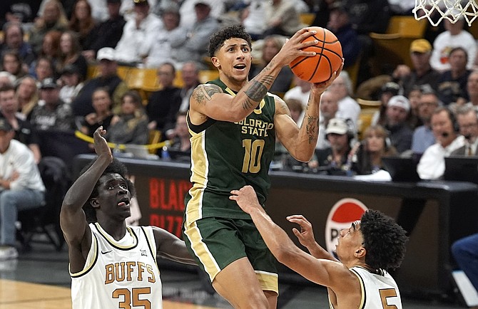 Colorado State guard Nique Clifford (10) drives between Colorado’s Assane Diop (35) and RJ Smith (5) in the teams’ game on Dec. 7.