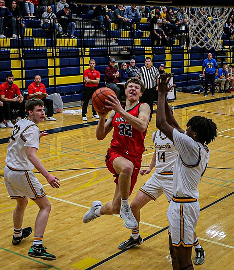 Snohomish Panther freshman James Flores jams for the net during first quarter play.
The Snohomish Boys Basketball team produced a 45-41 win over Everett on a cold Friday, Dec. 20 in Everett. Both teams played competitively throughout. 
The first period was slow as both teams used long looping passes to run down the shot clock.  In the second quarter, the pace quickened with the Panthers leading  24 - 17.  Snohomish Coach Jeff Larson controlled the game pace with timeouts leading to a still close third quarter, Panthers leading  34 - 31.  The Panthers drove the fourth period with bombing three-pointers, and a drama tie late in the period as the Panthers  rallied to take the win.