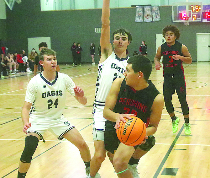 Efrain Aceves (30) looks for a teammate as Oasis defenders Trevor Barrenchea (24) and Fenn Mackedon (25) close in Wednesday.