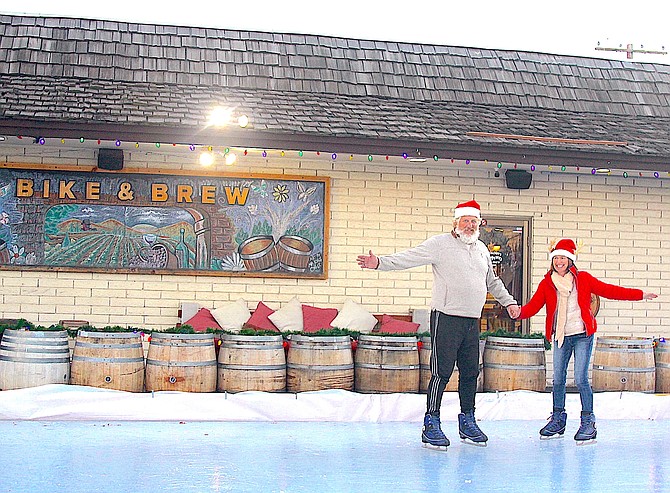 Big Daddy’s Bike & Brew owner Keith Hart and wife Monica test the ice skating rink Keith built at the shop.