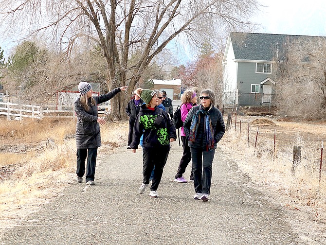 Winter solstice walkers spot a rainbow on Saturday during a drizzly first day of winter near Heritage Park in Gardnerville on Saturday.