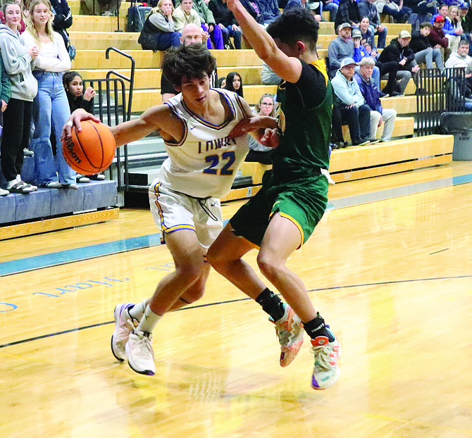 Lowry's Brent Kenison drives to the basket during a home game against Battle Mountain on Dec. 17.