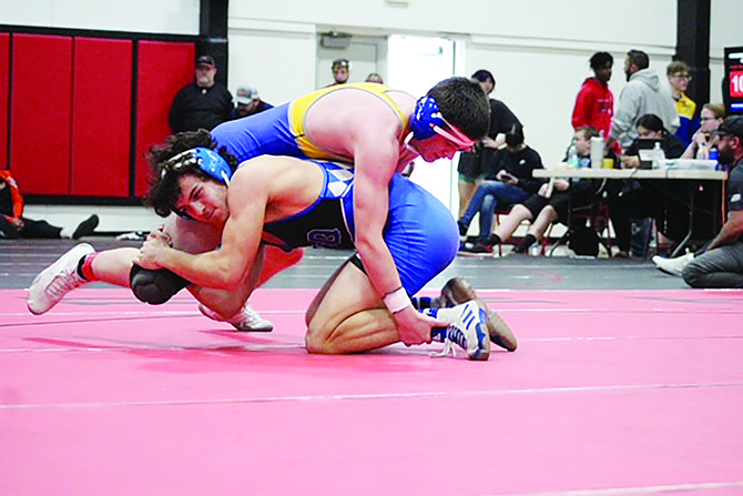 Lowry's Randy Patterson wrestlers McQueen's Gino Uccelli in a quarterfinal match at the Lovelock Invitational on Saturday.