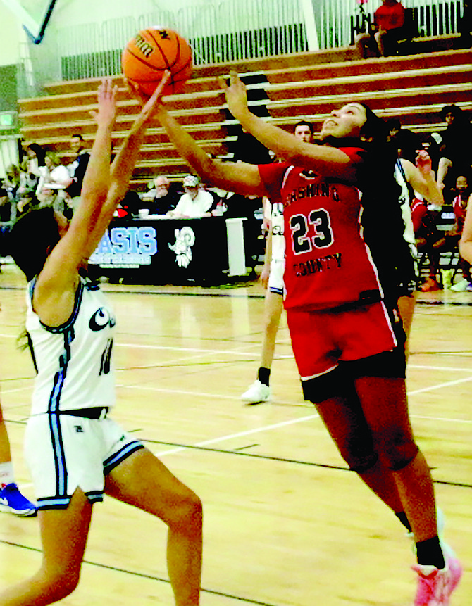 Lovelock’s Riley Harvey (23) drives for a one-handed layup against Oasis player Emma Lewis in Wednesday night’s game in Fallon.