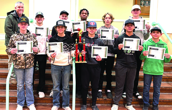 The Churchill County Middle School eighth-grade boys basketball team was recognized by the school board Dec. 18 as the Sagebrush League Champions. Front row, from left: Garrett Bartel, Timothy Kotsios, Hunter Gregory, Daemian Bueno and Carter Larson. Back row, from left: Trustee Matt Hyde, Camden Richardson, Emmitt Sorensen, DeQuan Wallace, Samuel Vinsonhaler and Benjamin Urso.