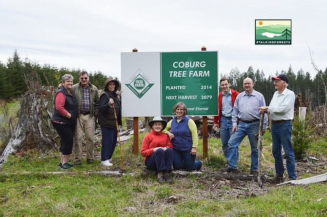 The entire Townsend Family by a Coburg Tree Farm planted 2014 next harvest 2079 sign.