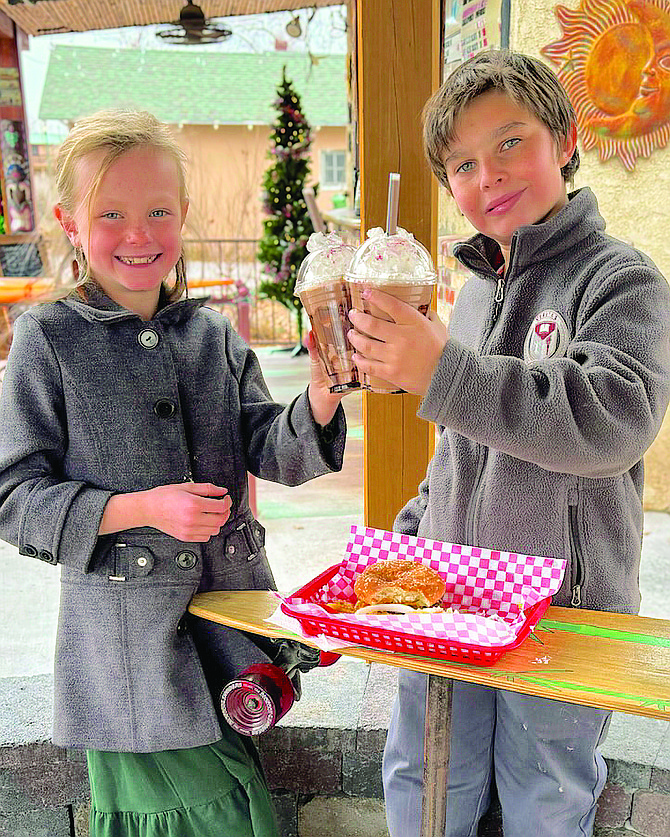 Veritas Preparatory School student Dixie Jensen wins top prize in the school’s See’s Candy fundraiser to spend the day as headmaster, including lunch with her friend, Charley Frey.