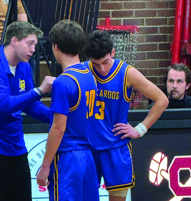 Lowry boys basketball coach Brandon Eastman talks with Matthew Casalez (20) and Txema Bengochea during a game with McQueen.