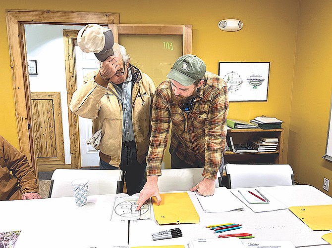 Jim Woods and Ben Sonnenberg go over a map at Whit Hall on Sunday for the Audubon Christmas Bird Count.