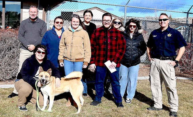 Members of Leadership Douglas County’s Class of 2024 with Kingsbury the dog on Friday at the Douglas County Animal Shelter.