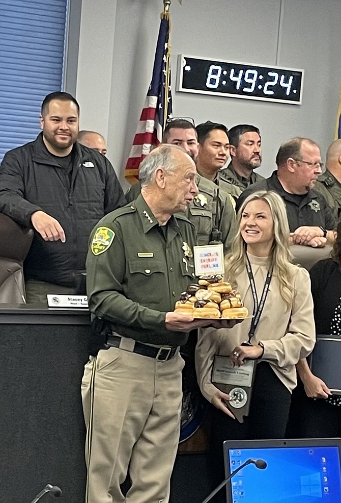 Carson City Sheriff Ken Furlong with a surprise plate of donuts at the Board of Supervisors meeting Thursday.