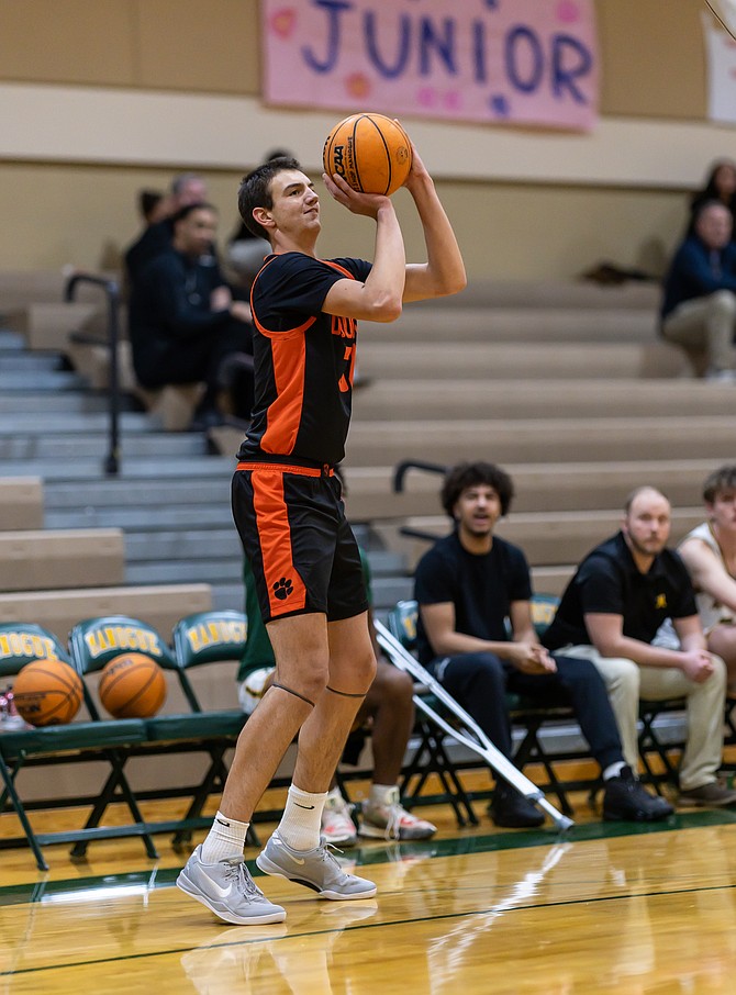 Douglas High senior Evan Tolbert steps out for a 3-pointer against Bishop Manogue in late December. The boys and girls basketball teams will take part in three league games this week.