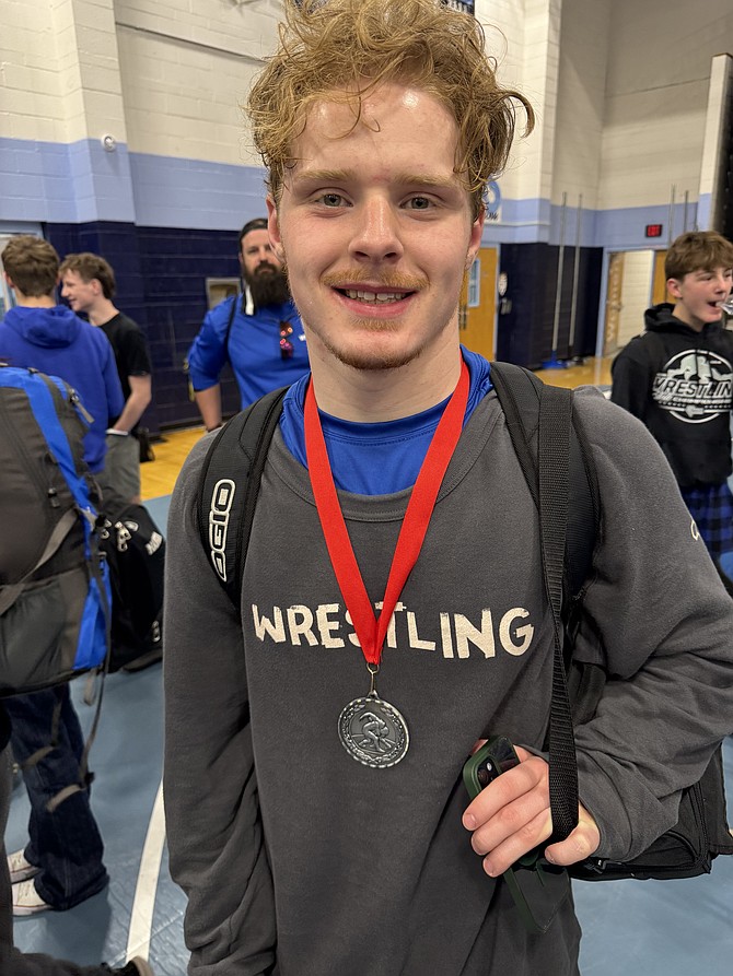 Carson High’s Konnor Crisp poses with his silver medal after taking second place at 175 pounds in the Centennial Bulldog Grappler tournament last weekend.