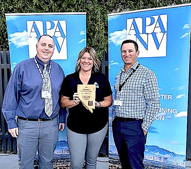 Brook Adie, center, is flanked by Nevada APA Chapter President Scott Carey and Wood Rogers Senior Land Use-Transportation Planner Derek Kirkland.