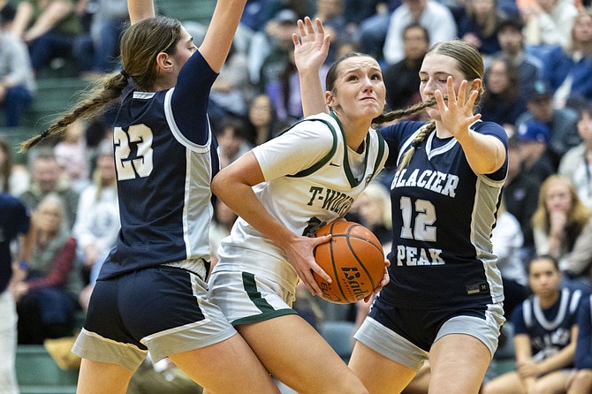 Jackson forward Makena Devine, a sophomore, attempts to reach up for a shot while guarded by Glacier Peak post Lillian Riechelson, a freshman, and Glacier Peak post Dylan Gordon, a senior, during Jackson and Glacier Peak’s basketball game at Jackson High School on Jan. 3.
Glacier Peak’s girls team crushed the Jackson Timberwolves, outscoring Jackson by 39 points. The final was 81-42.
The Jackson and Glacier Peak boys teams played that night too. Glacier Peak won 57-50, and has maintained a 6-0 (3-0 league) undefeated record as of press time.
The games were Wesco 4A in-conference match ups. The girls game result meant Glacier Peak handed Jackson its first in-conference defeat of this season.