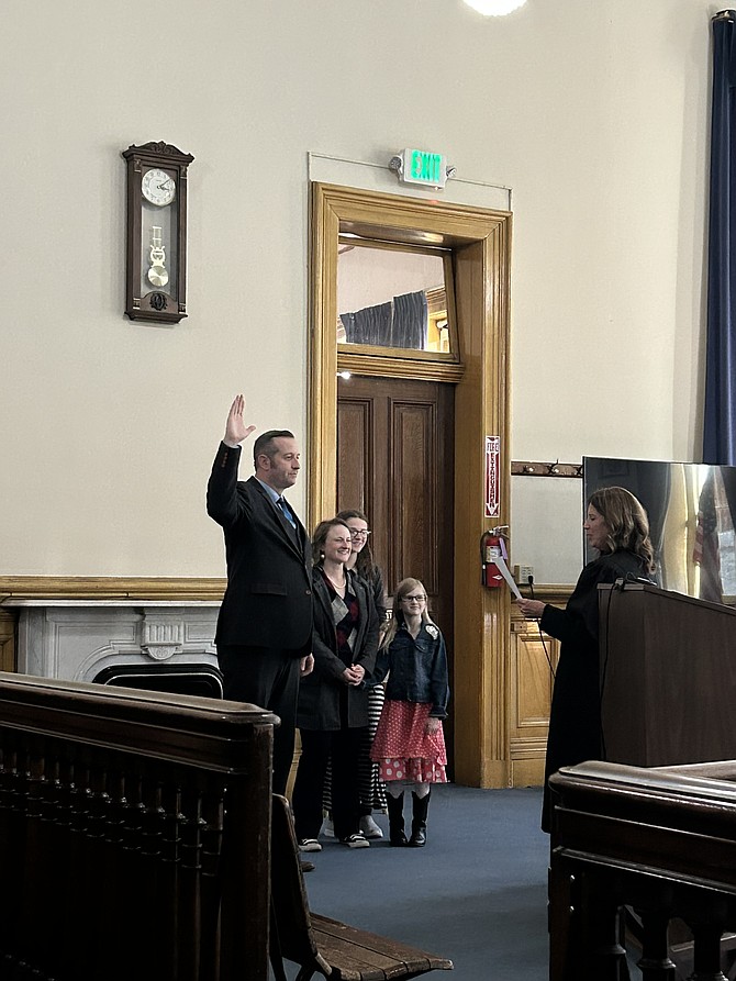 First Judicial Court Judge Jason Woodbury, right, congratulates Clay Mitchell who was sworn in as County Commissioner, District 1 at the Storey County Courthouse.